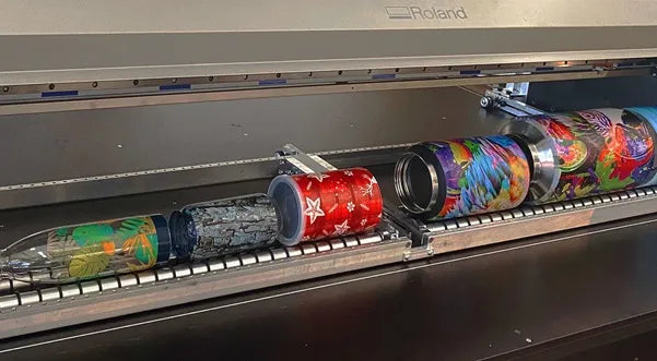 Many cylindrical bottles with prints applied to them